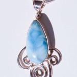 Sterling silver larimar pendent with swirls on the bottom.