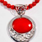 Sterling silver red coral pendent strung on red coral beads.