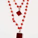 This sterling silver and carnelian necklace has two carnelian charms that hang at different lengths.